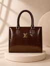 Dark Brown Croc-Texture Handbag on Minimalist Luxury Podium Backgroun